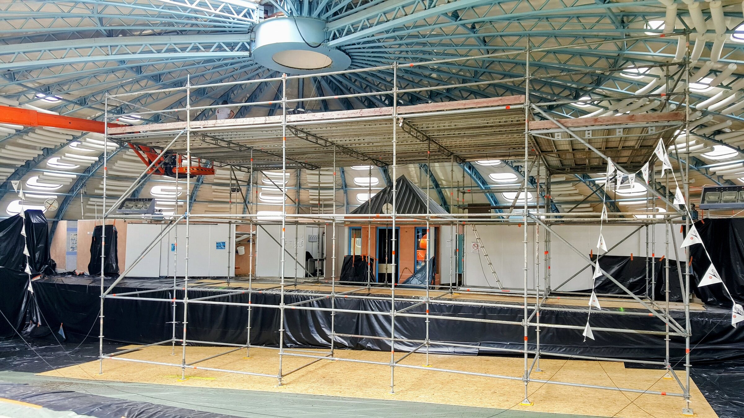 Échafaudage et plancher de travail montés sous une coupole, pour des travaux en hauteur à l'intérieur d'un bâtiment