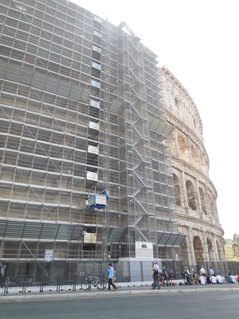 Lift de chantier MABER monté dans l'échafaudage de restauration du Colisée, à Rome, cage rouge sur mât